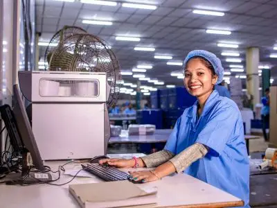 image showing a worker at a manufacturing plant making pool covers