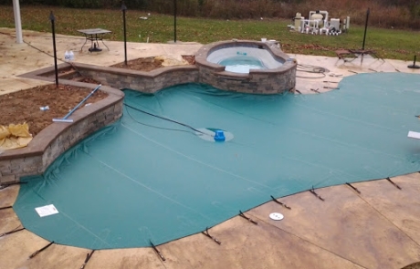 image of a pool cover on a pool that was designed upfront for safety of children and pets and weather resistant to stay safe over time