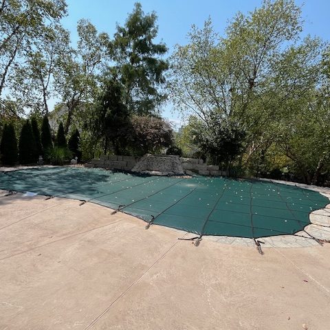 image showing a pool cover that was replaced and matched the natural surroundings for the home