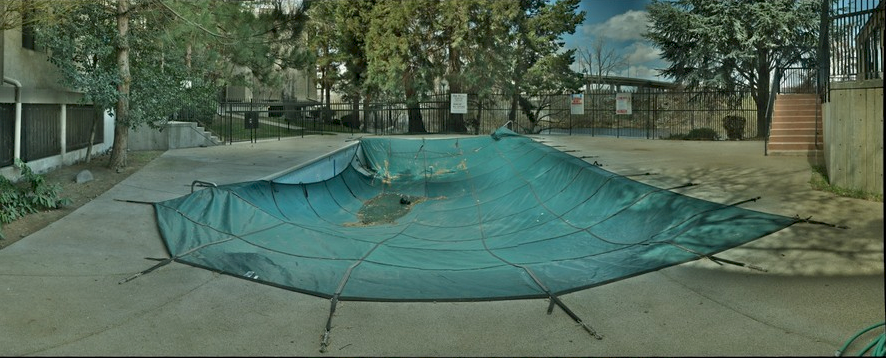 image showing a damaged swimming pool cover that has been stretched torn and shrunk in other spots creating a bad model to measure from