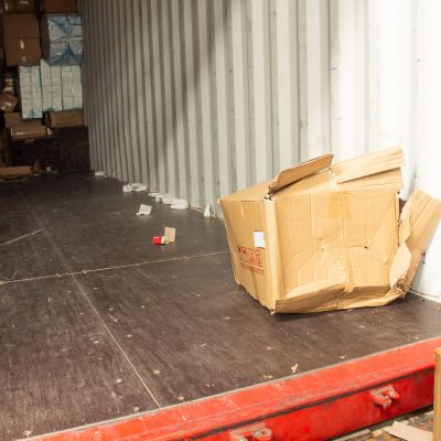 picture of a really damaged box during shipping that is set aside in the shipping truck to discard of before reaching it's destination